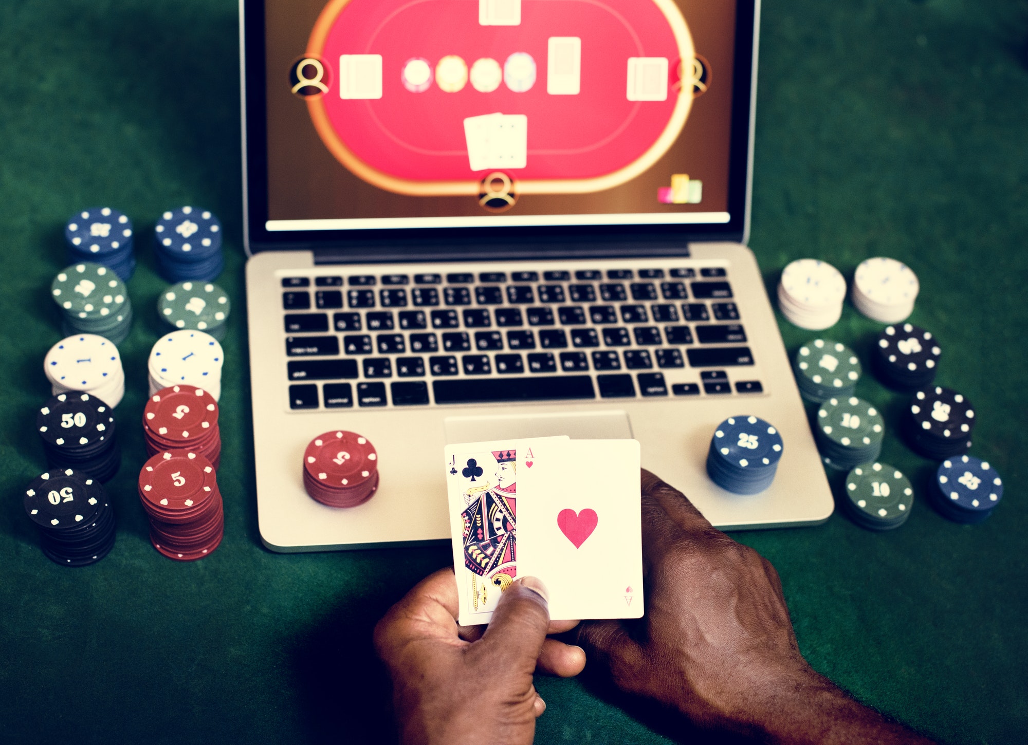 hand-holding-card-playing-online-gamblin